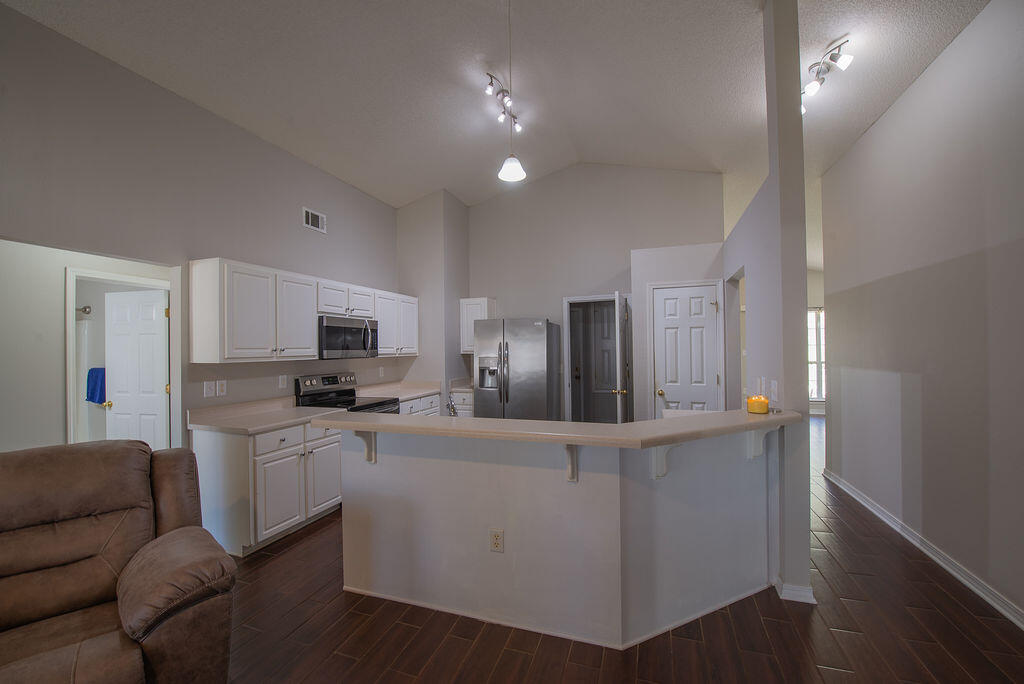 903 Lajolla Lane Mary Esther, FL 32569 - Photo 21 of 47 a kitchen with stainless steel appliances kitchen island sink refrigerator and stove