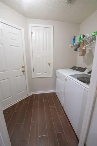 a utility room with sink dryer and washer