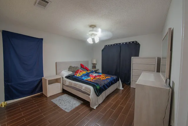 a living room with furniture and a dresser