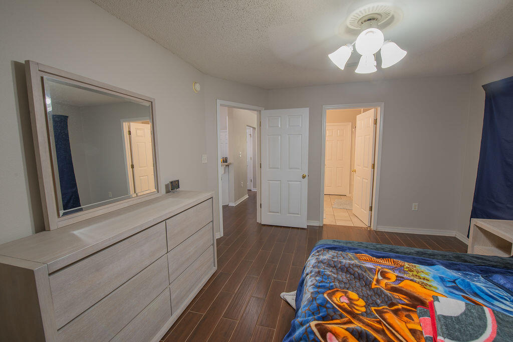 903 Lajolla Lane Mary Esther, FL 32569 - Photo 29 of 47 a bedroom with a bed and a chandelier