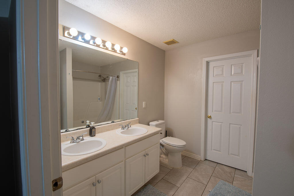 903 Lajolla Lane Mary Esther, FL 32569 - Photo 34 of 47 a bathroom with a double vanity sink and a mirror