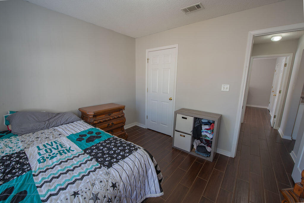 903 Lajolla Lane Mary Esther, FL 32569 - Photo 36 of 47 a bedroom with a bed and a dresser