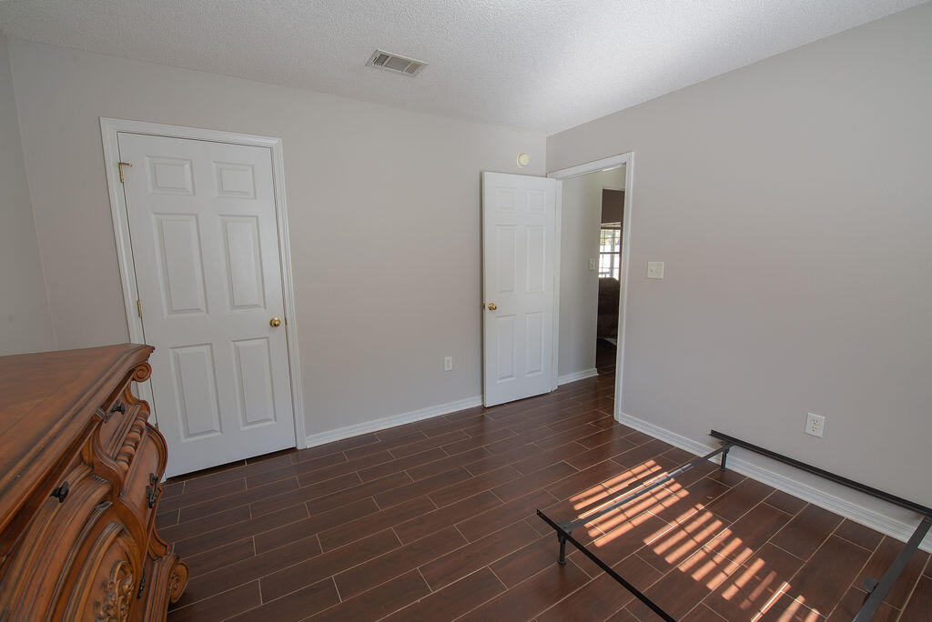 903 Lajolla Lane Mary Esther, FL 32569 - Photo 38 of 47 a view of an empty room with wooden floor and a window