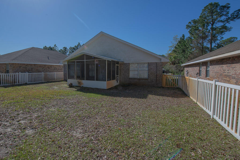 903 Lajolla Lane Mary Esther, FL 32569 - Photo 41 of 47 a front view of a house with a yard and garage