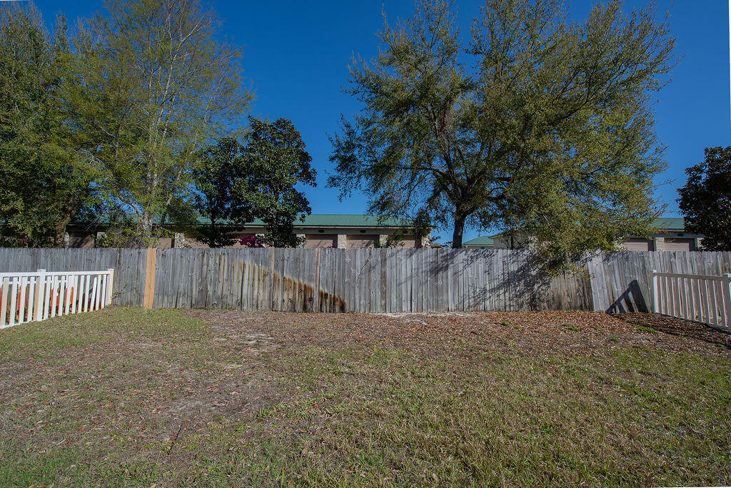 903 Lajolla Lane Mary Esther, FL 32569 - Photo 47 of 47 a view of a backyard with wooden fence