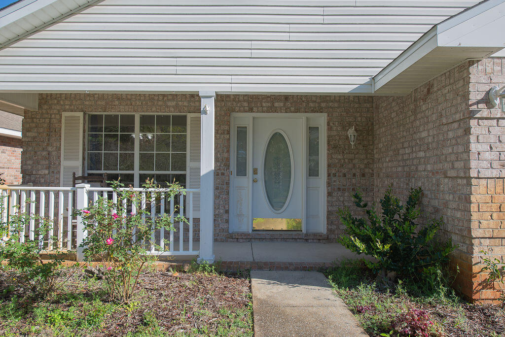 903 Lajolla Lane Mary Esther, FL 32569 - Photo 5 of 47 a front view of a house with a garden