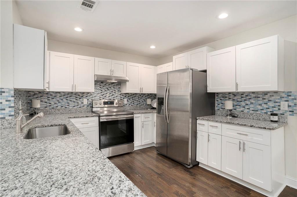 1347 Dorothy Drive Decatur, GA 30030 - Photo 10 of 38 a kitchen with stainless steel appliances granite countertop a sink stove and refrigerator