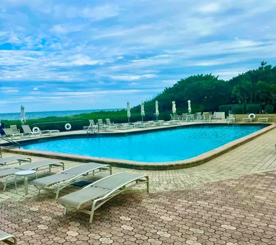 a view of a swimming pool with an ocean view