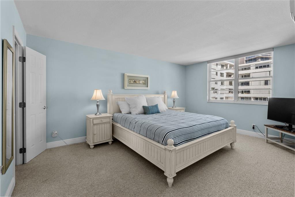 1900 South Ocean Boulevard, Unit 5F Pompano Beach, FL 33062 - Photo 8 of 23 a bedroom with a bed and a desk