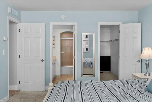 a bedroom with two beds and painting on the wall