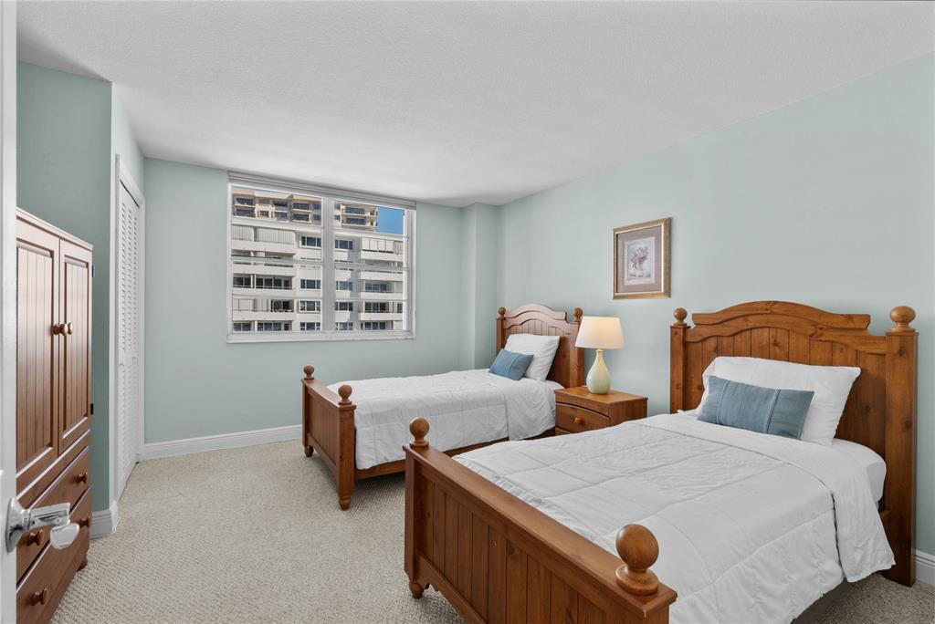 1900 South Ocean Boulevard, Unit 5F Pompano Beach, FL 33062 - Photo 10 of 23 a bedroom with two beds and painting on the wall