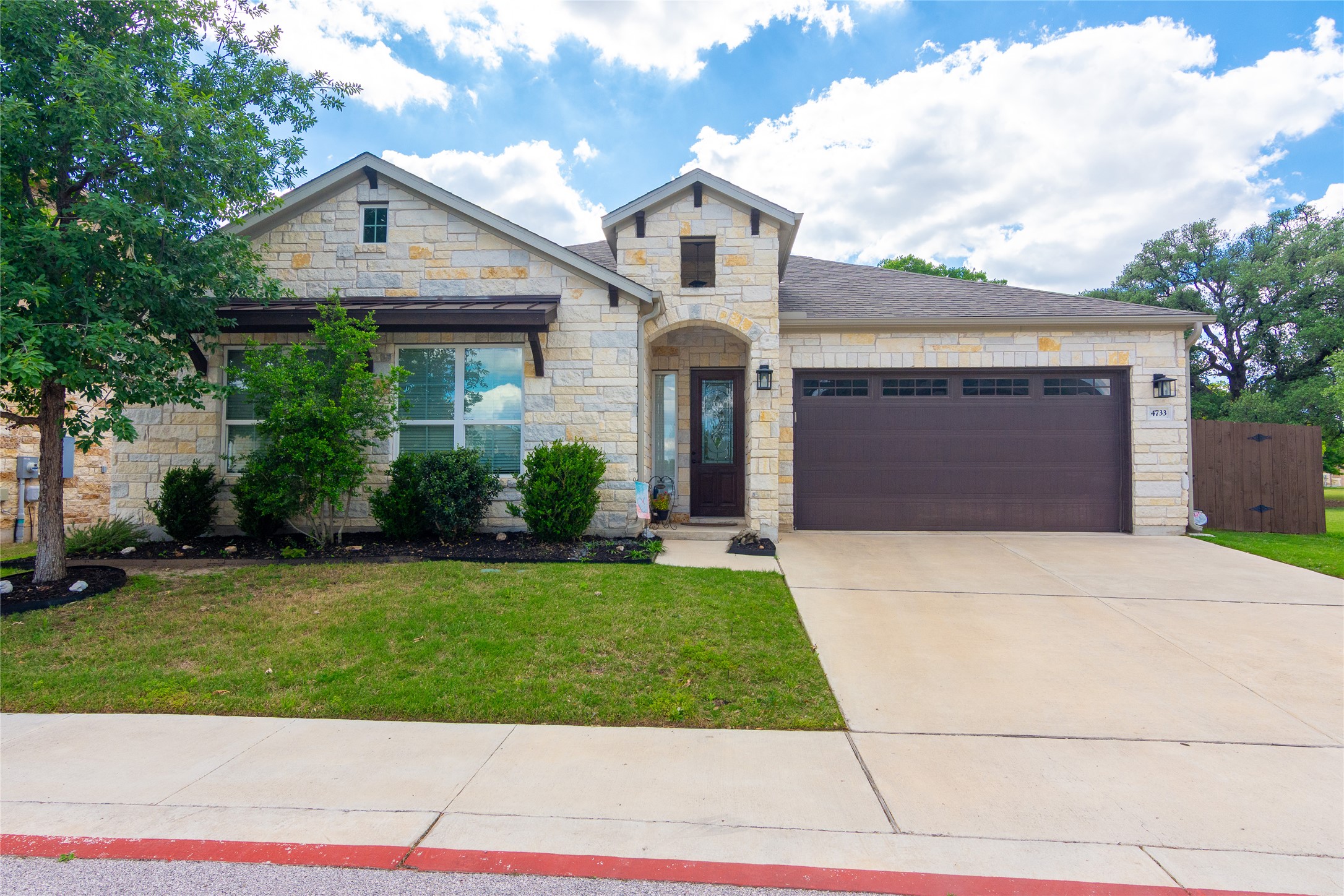 4733 Collins Street, Unit 610 Round Rock, TX 78628 - Photo 1 of 36 a front view of a house with a yard and garage
