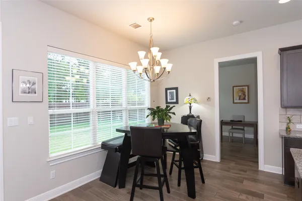a view of a dining room with furniture and window