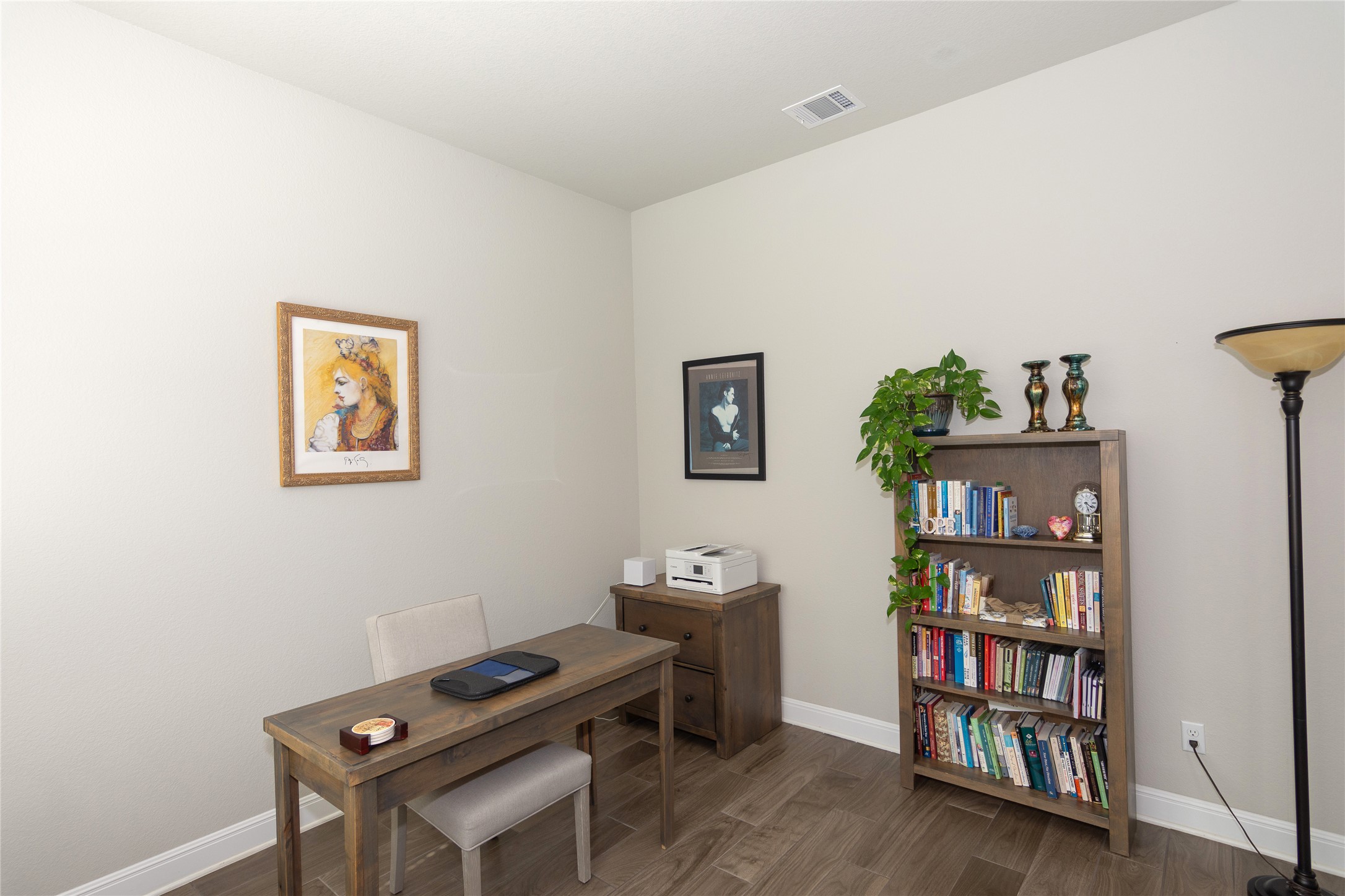4733 Collins Street, Unit 610 Round Rock, TX 78628 - Photo 17 of 36 a room with a bookshelf and a wooden floor