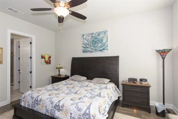 a bedroom with a bed and a chandelier