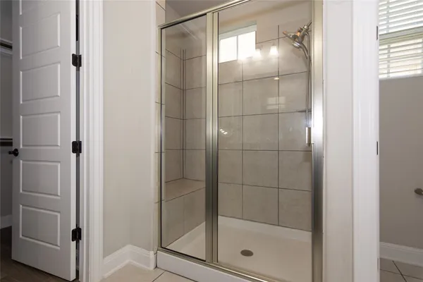a bathroom with a glass shower door