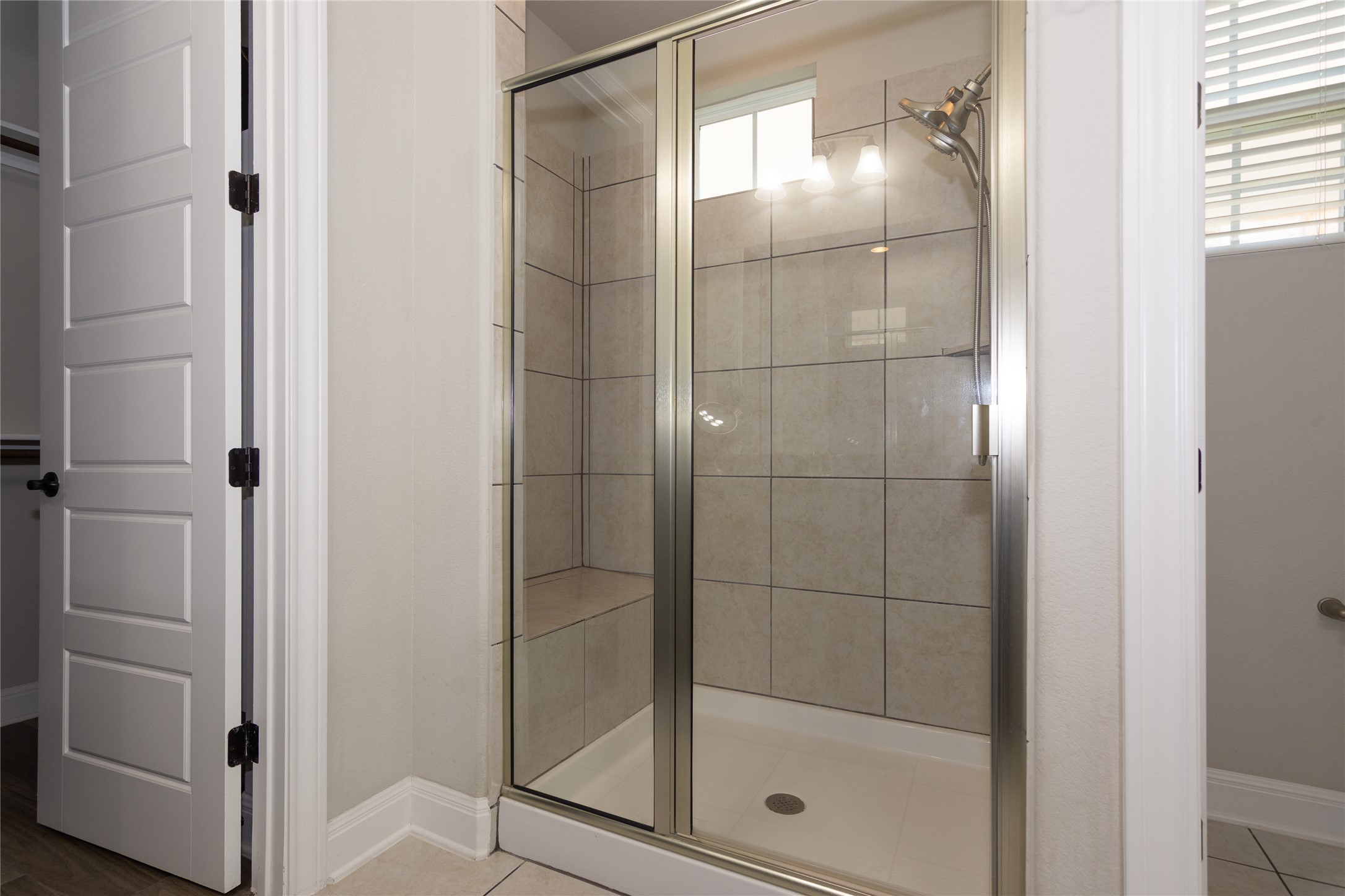 4733 Collins Street, Unit 610 Round Rock, TX 78628 - Photo 21 of 36 a bathroom with a glass shower door