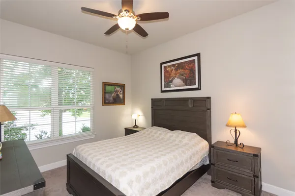 a bedroom with a bed and a lamp