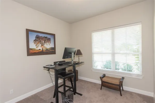 a view of a workspace with a window and a chair