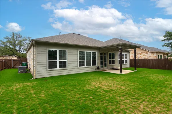 a view of a house with a yard and sitting area