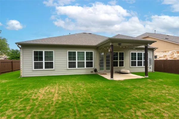a view of a house with a yard and a large window