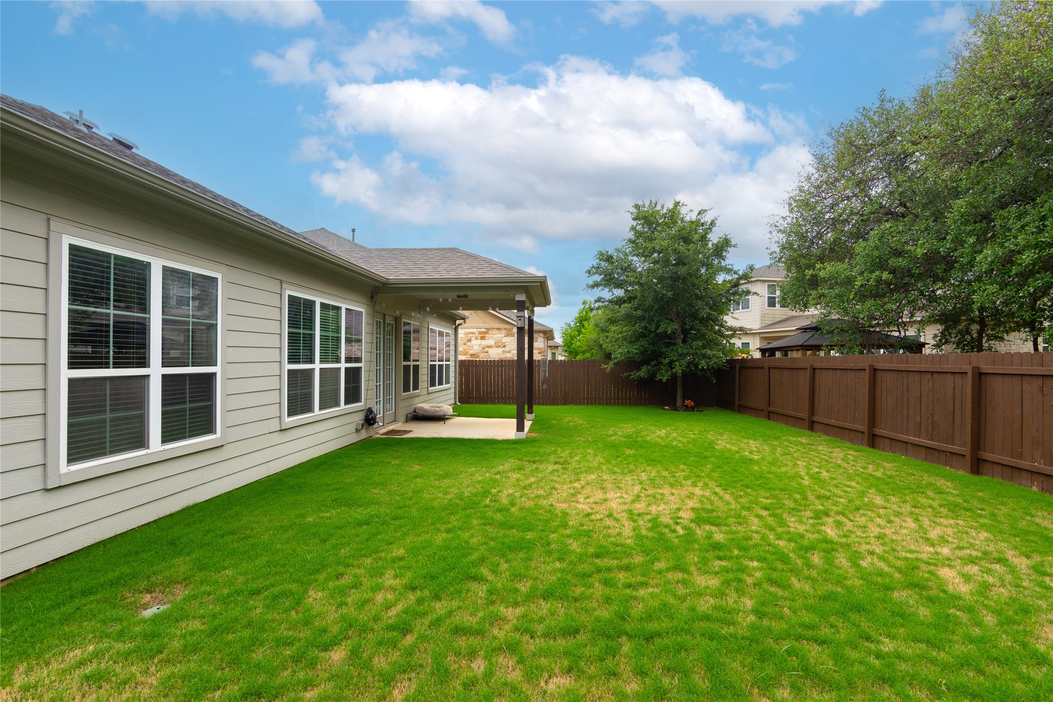 4733 Collins Street, Unit 610 Round Rock, TX 78628 - Photo 35 of 36 a view of a house with backyard garden and trees