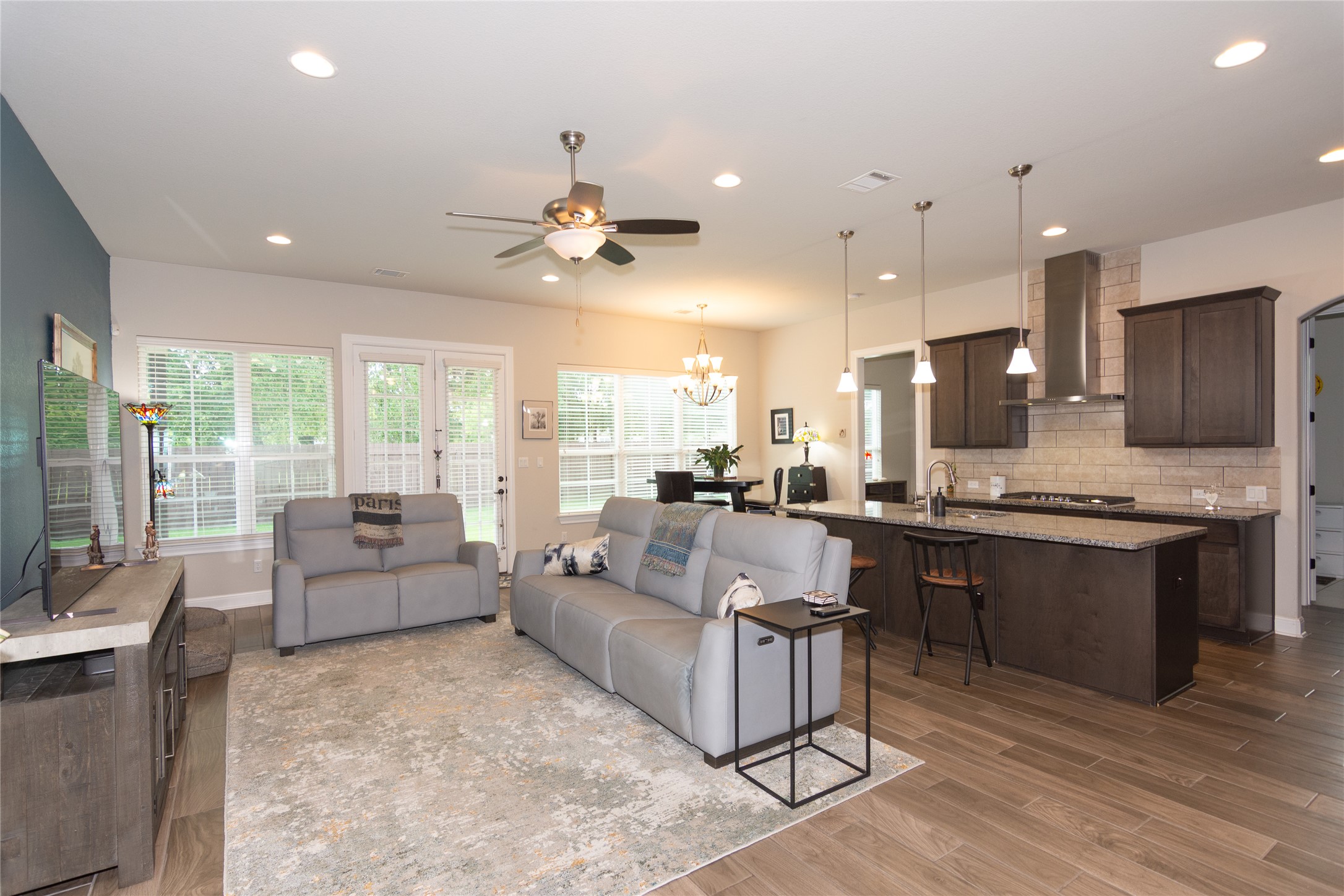 4733 Collins Street, Unit 610 Round Rock, TX 78628 - Photo 7 of 36 a large living room with stainless steel appliances kitchen island granite countertop a couch and a view of kitchen