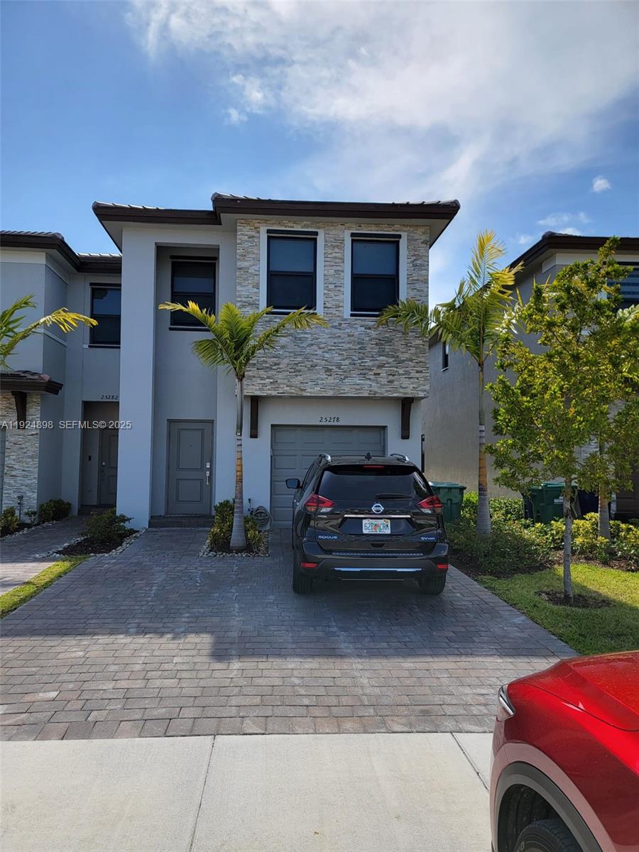 25278 Southwest 108th Avenue, Unit 1 Homestead, FL 33032 - Photo 1 of 10 a view of a car parked in front of a house