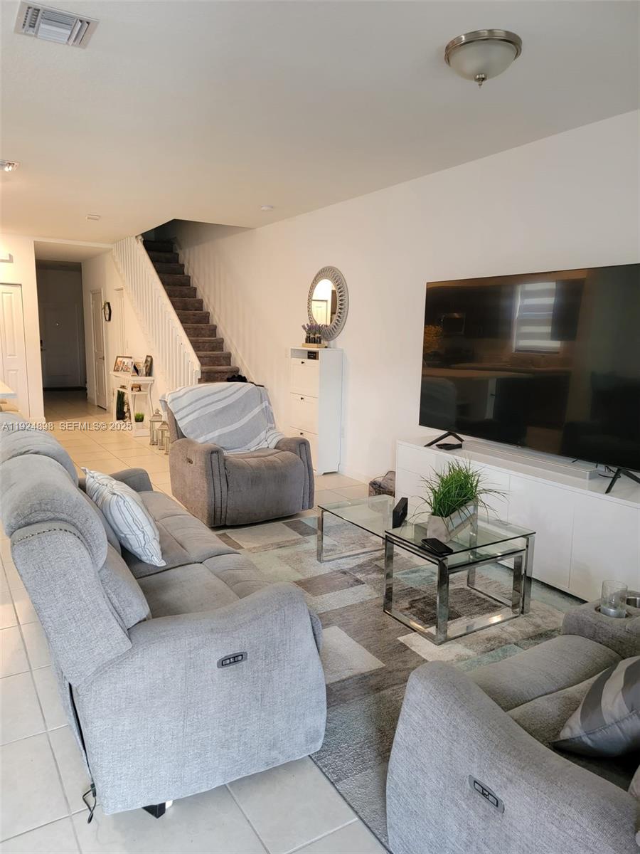 25278 Southwest 108th Avenue, Unit 1 Homestead, FL 33032 - Photo 6 of 10 a living room with furniture and a flat screen tv