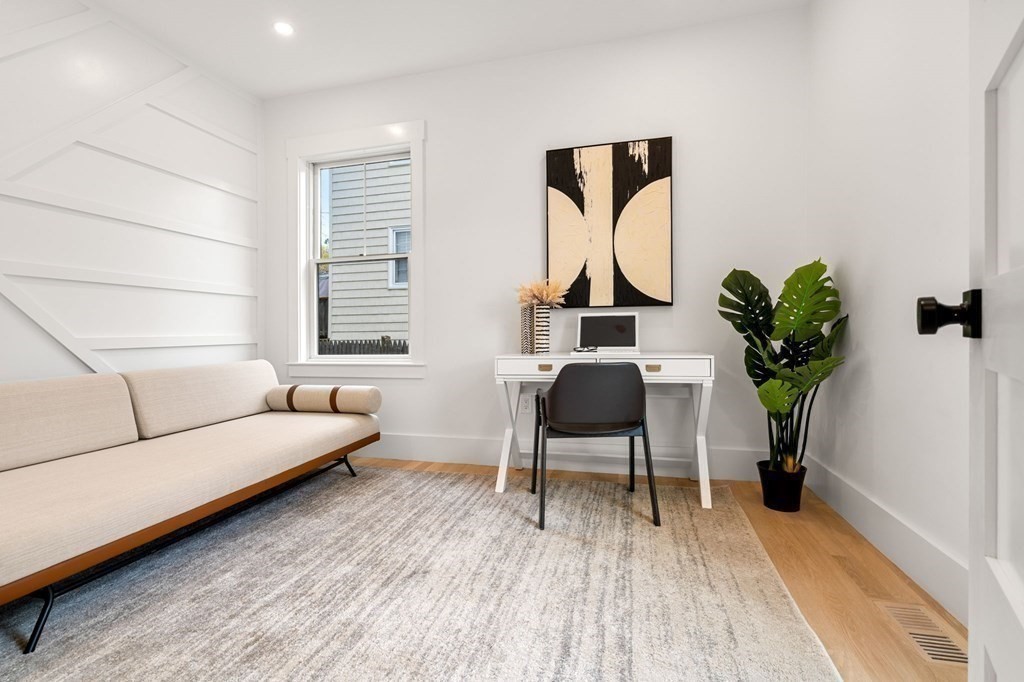 136 Wright Street Arlington, MA 02474 - Photo 12 of 38 a living room with furniture a wooden floor and a potted plant