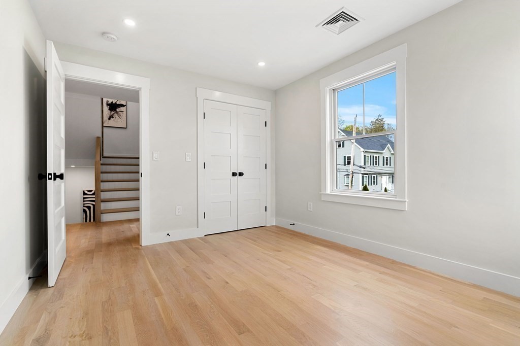 136 Wright Street Arlington, MA 02474 - Photo 14 of 38 wooden floor in an empty room with a window
