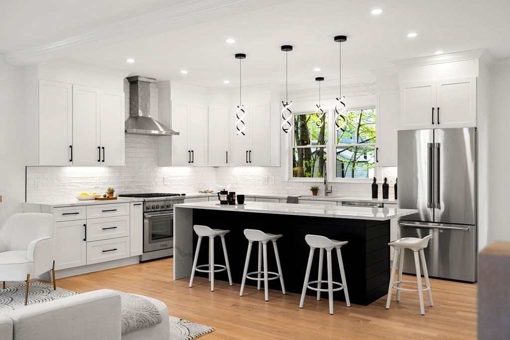 136 Wright Street Arlington, MA 02474 - Photo 3 of 38 a kitchen with stainless steel appliances granite countertop a table chairs stove a sink and a refrigerator