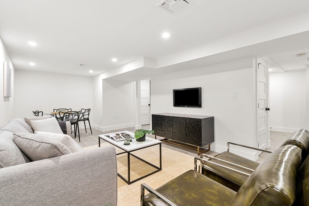 136 Wright Street Arlington, MA 02474 - Photo 34 of 38 a living room with furniture and a flat screen tv