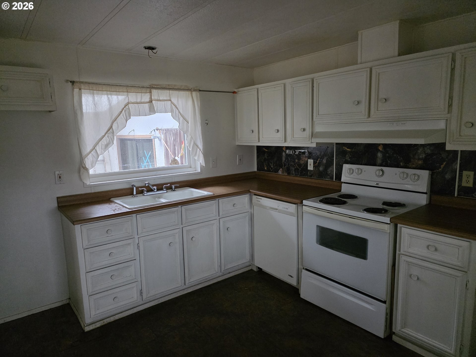 81876 Highway 395 Hermiston, OR 97838 - Photo 3 of 10 a kitchen with granite countertop white cabinets and white appliances
