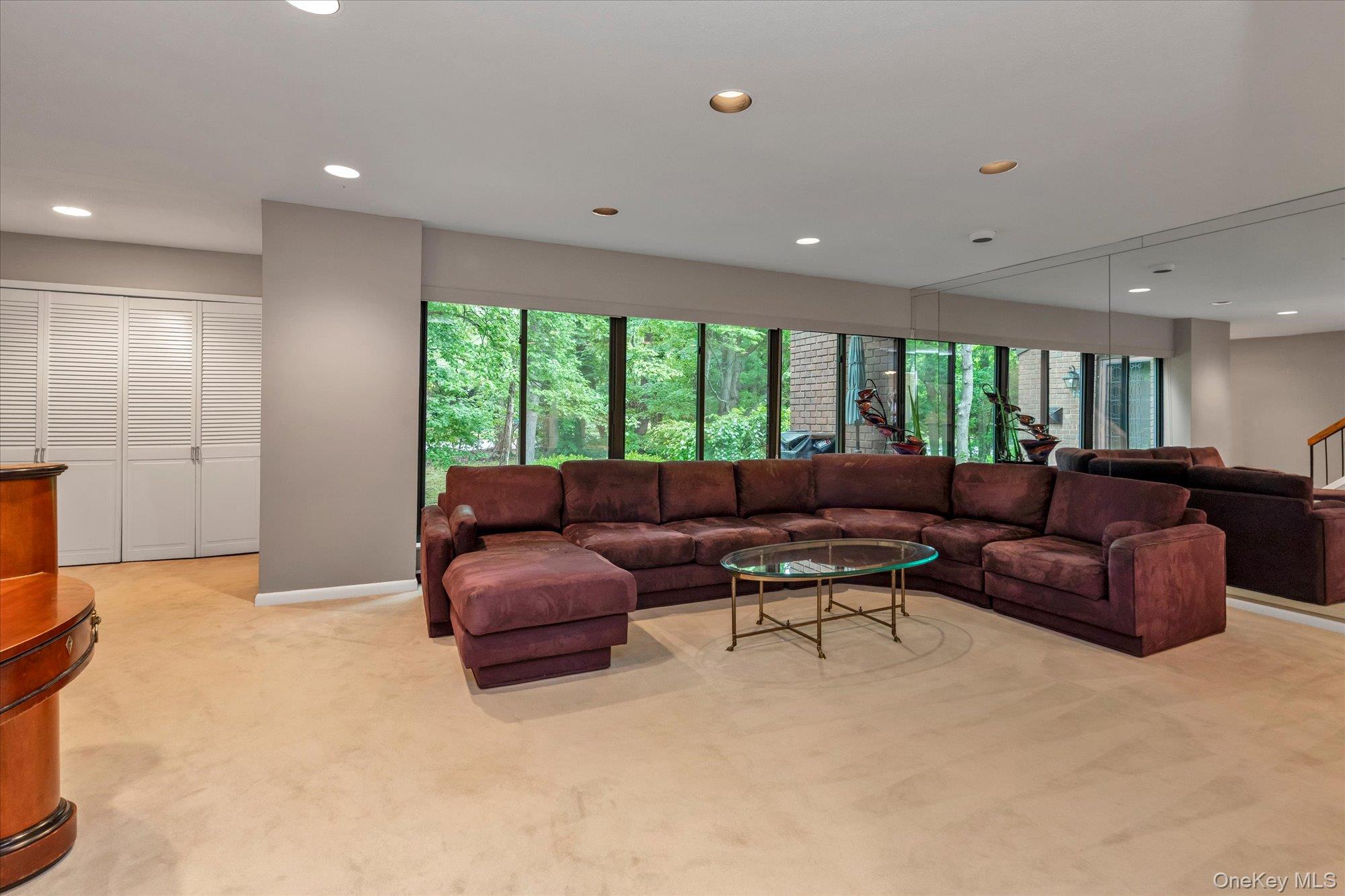41 Spring Hollow Road Roslyn, NY 11576 - Photo 3 of 27 a living room with a couch and a large window