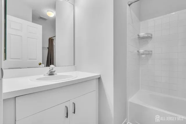 a bathroom with a bathtub and a sink