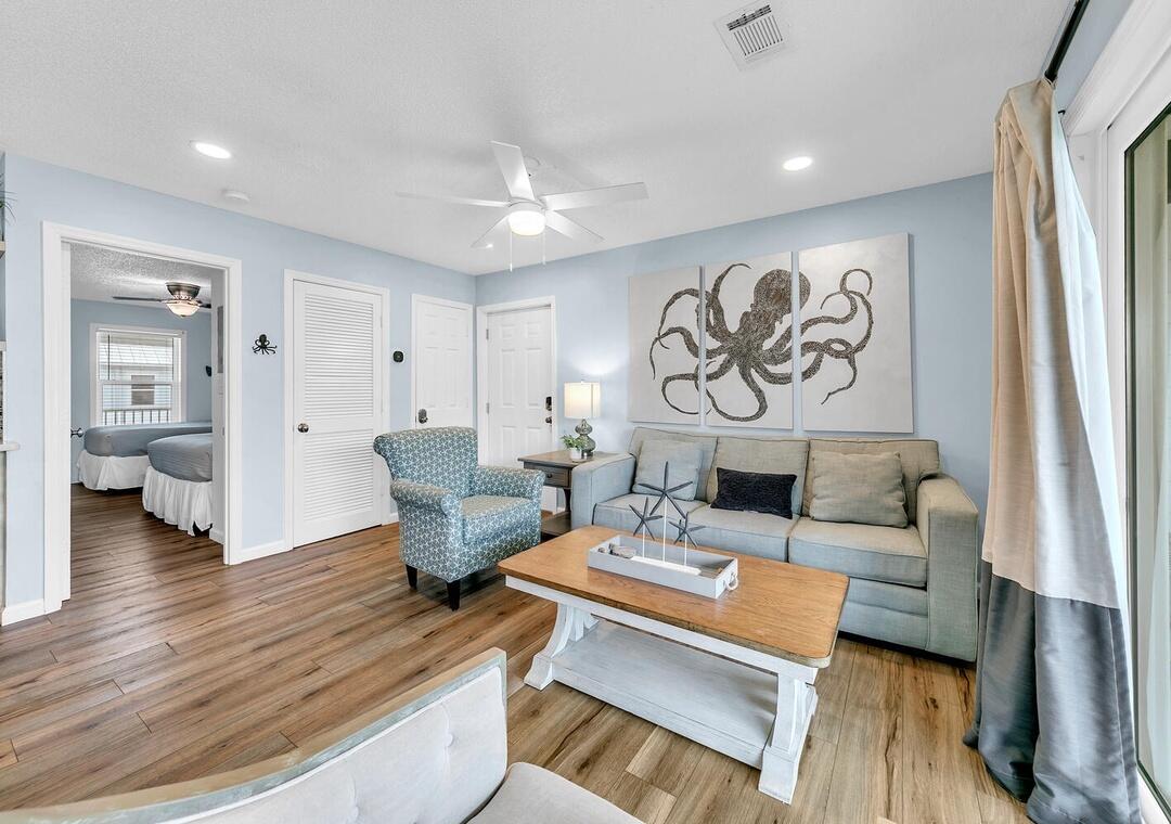 11 Beachside Drive, Unit 832 Santa Rosa Beach, FL 32459 - Photo 2 of 23 a living room with furniture and wooden floor