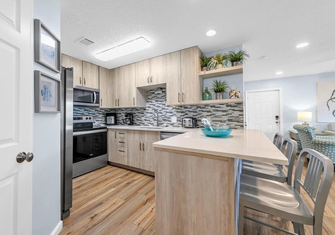 11 Beachside Drive, Unit 832 Santa Rosa Beach, FL 32459 - Photo 8 of 23 a kitchen with stainless steel appliances a refrigerator sink and microwave