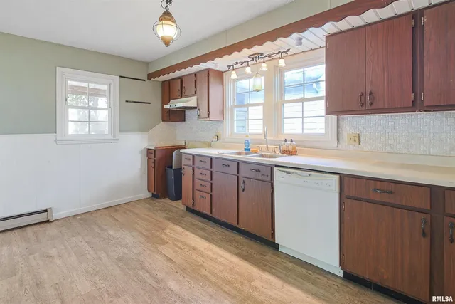 a kitchen with a sink window and cabinets