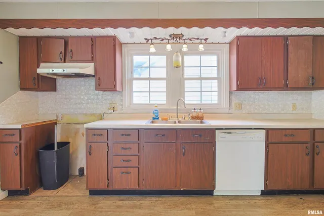 a kitchen with a sink cabinets and window