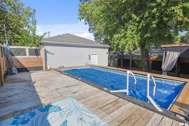 a view of backyard with deck and wooden floor