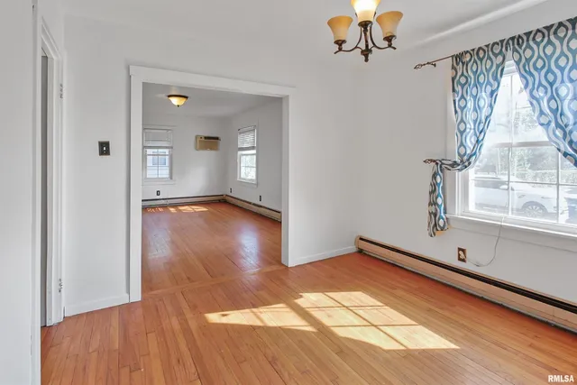 a view of room with window and wooden floor