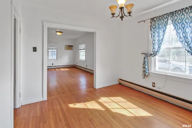 a view of room with window and wooden floor