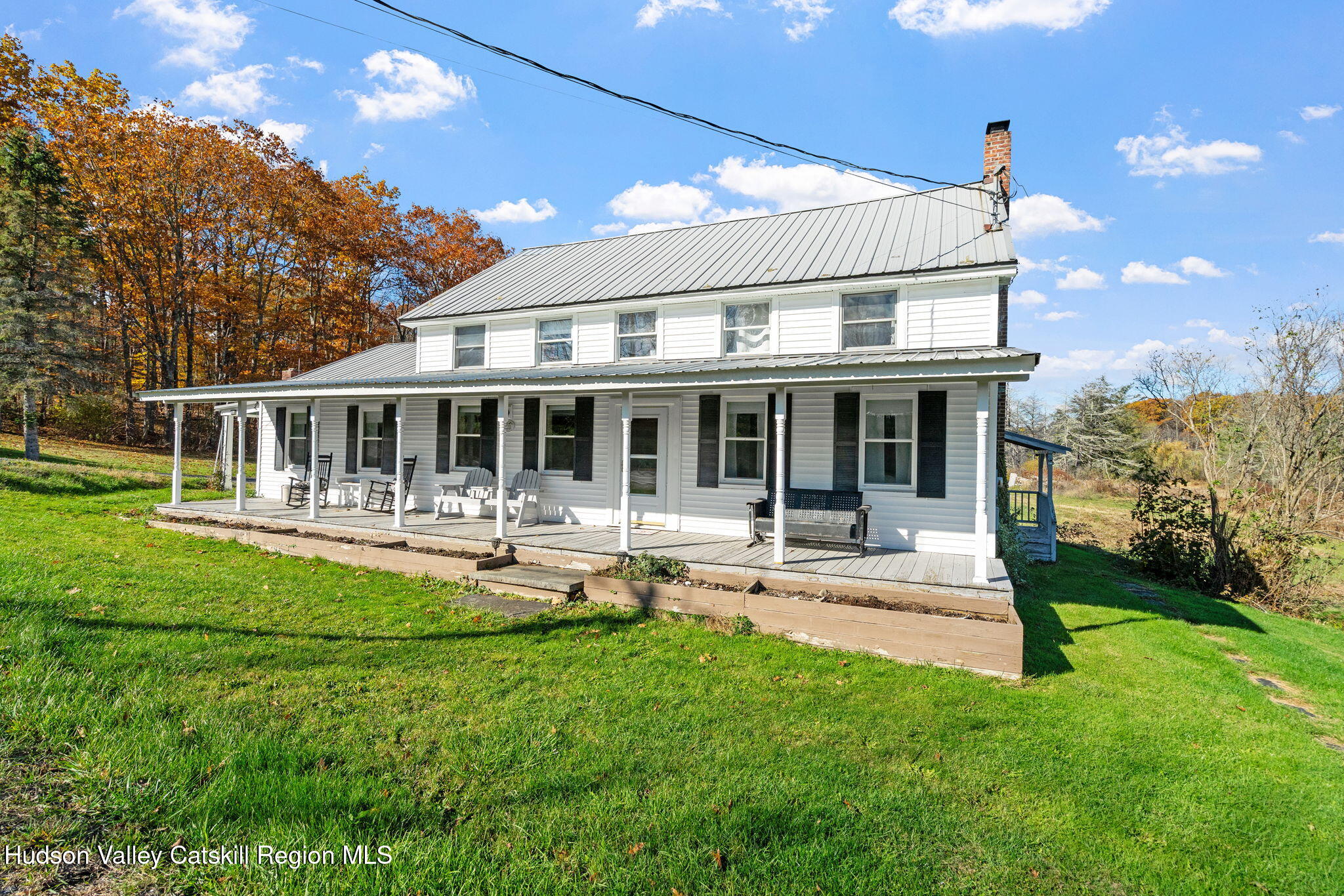295 County Rte 403 Greenville, NY 12083 - Photo 1 of 65 a front view of a house with a yard table and chairs