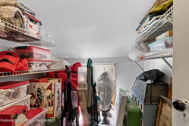 a view of a chairs and table in the patio next to a yard