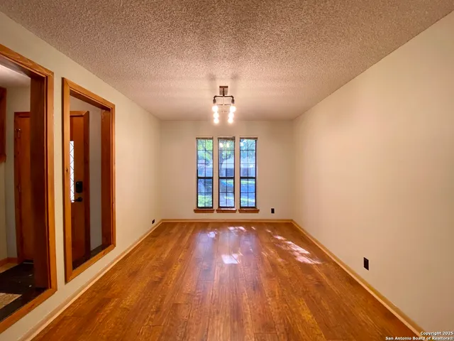 a kitchen with stainless steel appliances granite countertop a refrigerator a sink dishwasher a stove with wooden cabinets