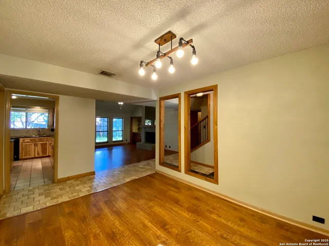 a kitchen with stainless steel appliances granite countertop a refrigerator a stove and a sink with granite countertops