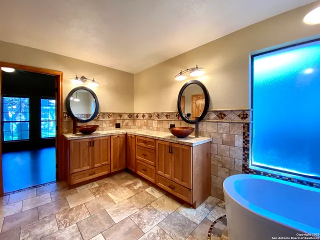 a bathroom with a double vanity sink and a mirror