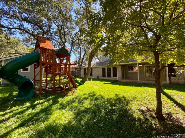 a view of an empty room with window and fireplace