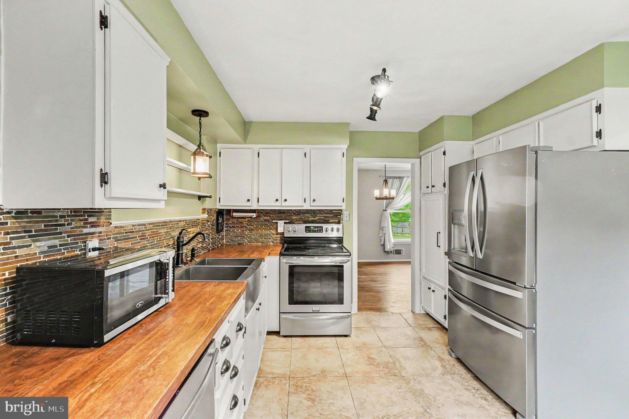 201 Mountain Road Fallston, MD 21047 - Photo 15 of 35 a kitchen with granite countertop a refrigerator oven and stainless steel appliances